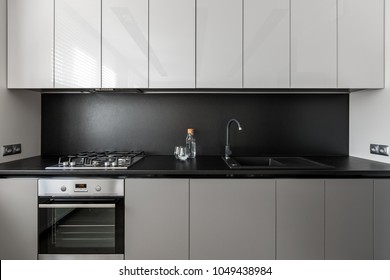 Modern Kitchen Unit In Black And White, Black Worktop And Backsplash