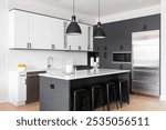 A modern kitchen with white and black cabinets, bar stools sitting at a large island, black pendant lights hanging over the marble countertop, and a subway tile backsplash. No brands or labels.