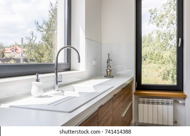 Modern Kitchen With White Worktop, Sink And Big Window