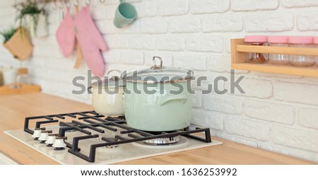 Modern kitchen wit white wall and pots on strove