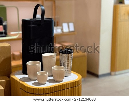 Modern kitchenware set with thermos and cups on display. Minimalist home style, product assortment and interior design for contemporary lifestyle.