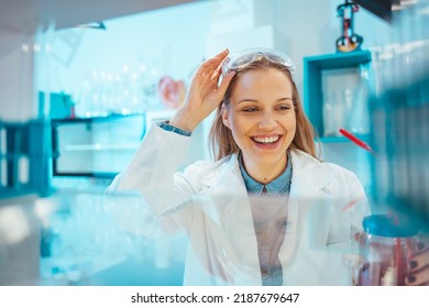 Modern laboratory interior. Woman working on medical samples in background. Young female scientist standing in her lab. Young Female Scientist Working in The Laboratory