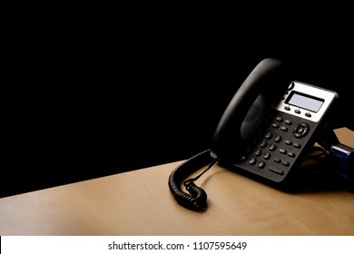 Modern Landline Phone On The Table And Darrk Background