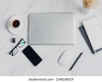 modern lap top template mock up on white and clean work desk with blank screen Workspace desk, laptop, coffee cup and pen laptop mock up screen view. work from home concept - Shutterstock ID 2140148319