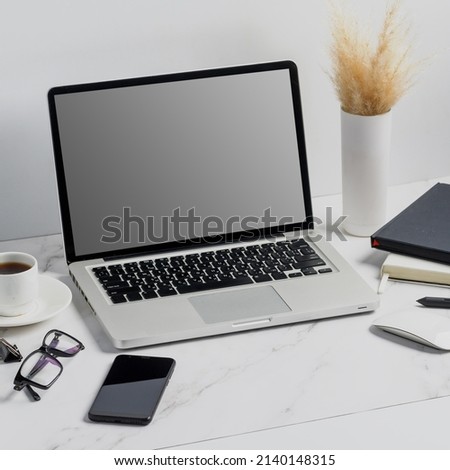 modern lap top template mock up on white and clean work desk with blank screen Workspace desk, laptop, coffee cup and pen laptop mock up screen view. work from home concept