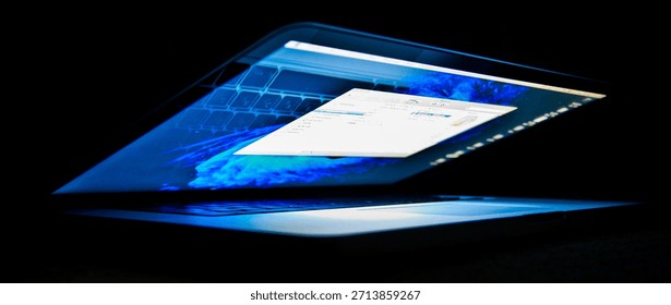Modern laptop with floating software window and digital interface on dark background 