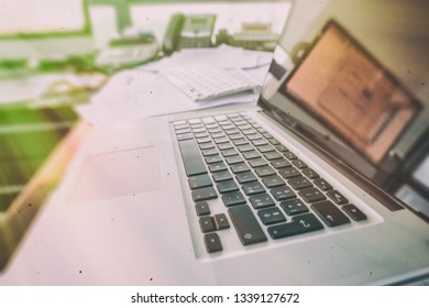 Modern Laptop On A Chaotic Desk, Modern Office Interior.