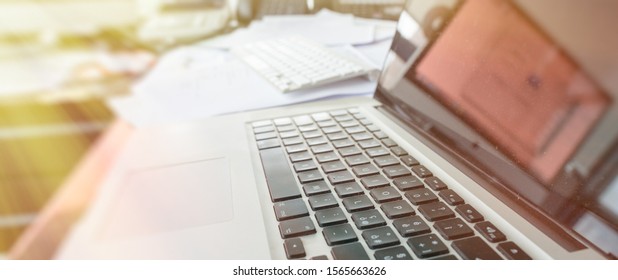 Modern Laptop On A Chaotic Desk, Modern Office Interior.