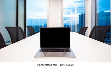 Modern Laptop On Foreground At Meeting Room With Large Windows, Outside Building, City, Tower View, Soft Focus