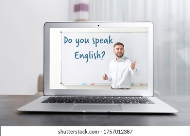 Modern Laptop For Online English Learning With Teacher On Table Indoors