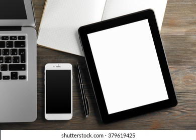 Modern Laptop, Tablet, Mobile Phone And Notebook On The Table, Close-up