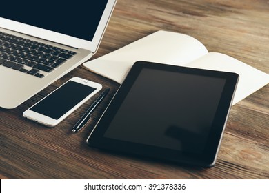 Modern Laptop, Tablet, Mobile Phone And Notebook On The Table, Close-up