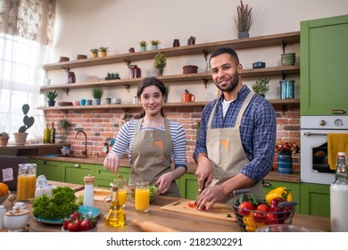 Modern And Large Kitchen Happy And Enthusiastic Couple Man And Pretty Caucasian Woman Cooking Together The Dinner