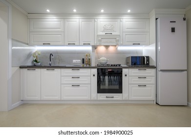 Modern large luxurious white kitchen interior, whole front view