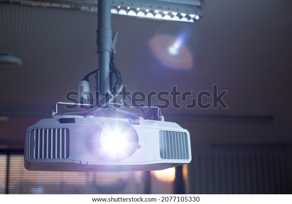 Modern laser projector in a conference\
room . LCD Projector technology video\
presentation
