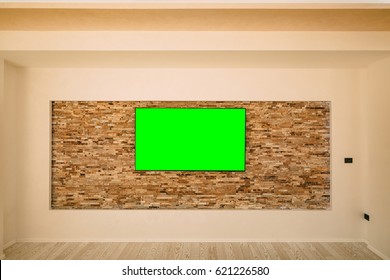 A Modern LCD TV With A Green Screen Hanging On The Wall.