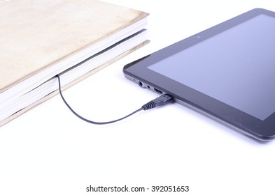 Modern learning concept with an encyclopedia and touch screen computer