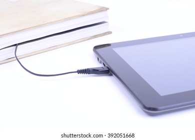 Modern learning concept with an encyclopedia and touch screen computer