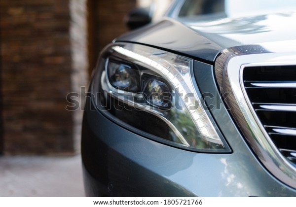 Modern LED car\
headlight. Luxury class car\
