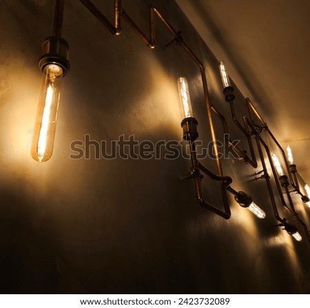 Modern led light made from water pipes. Rustic design, stucco wall with light bulbs and pipes. Lights. Lightbulb. Electricity. Illumination