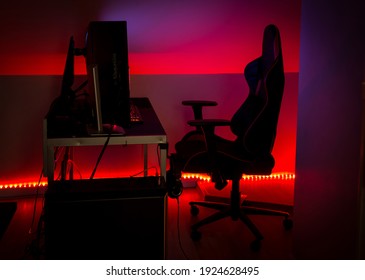 Modern LED Red Ambient Light Around Gaming Computer Set At Home. Home Decor Concept.