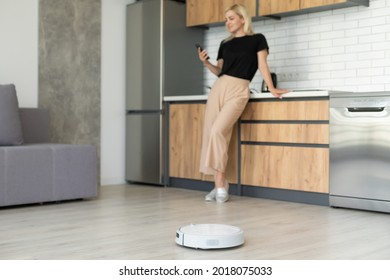 Modern Life Concept, Woman Relaxing , Automatic Robotic Hoover Clean The Room While