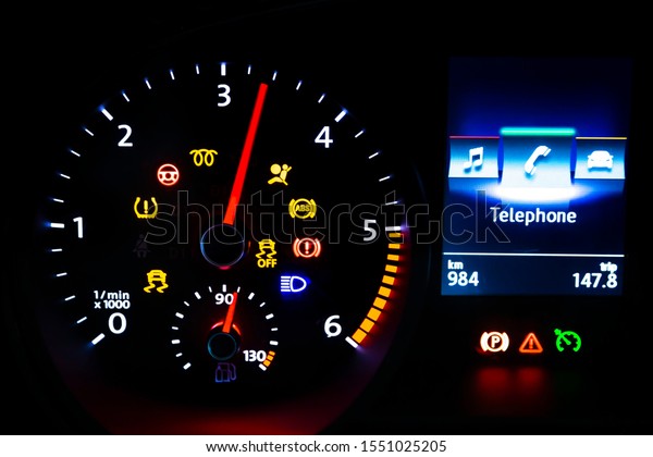 Modern light car mileage (dashboard, milage)\
isolated on a black background. New display of a modern car.\
Telephone.