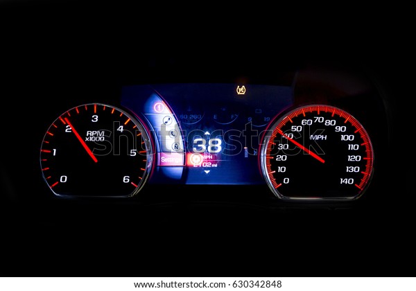 Modern light car mileage (dashboard, milage)\
isolated on a black background. New display of a modern car. RPM\
and 38 MPH.