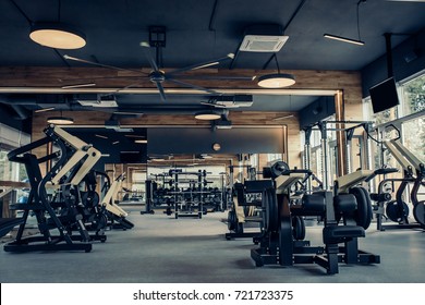 Modern light gym. Sports equipment in gym. Barbells of different weight on rack. - Shutterstock ID 721723375