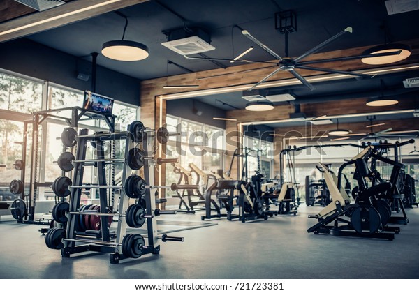 Modern light gym. Sports equipment in gym. Barbells\
of different weight on\
rack.