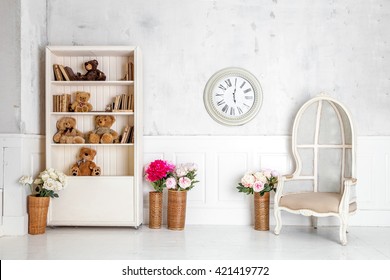 Modern Light Room Interior With Wardrobe, Armchair And Clocks On The Wall. Kids Room Interior