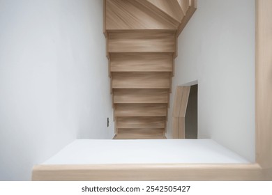 A modern, light-toned wooden staircase inside a contemporary home, showcasing clean lines and minimalistic design. - Powered by Shutterstock