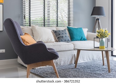 Modern Living Room With Modern Chair And Sofa With Vase Of Plants At Home