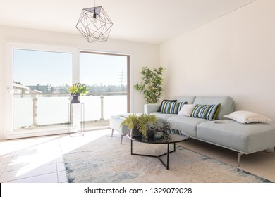 Modern Living Room With Designer Sofa And Coffee Table. Window With View. Nobody Inside