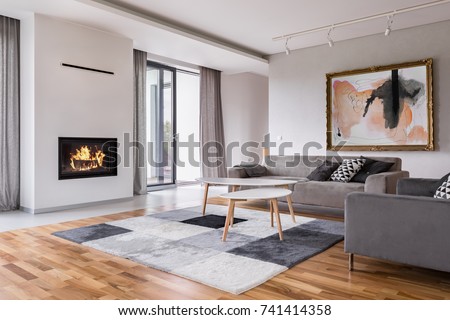 Modern living room with fireplace, sofa, balcony and pattern carpet