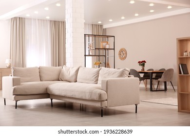 Modern living room interior with comfortable sofa and wooden table - Shutterstock ID 1936228639