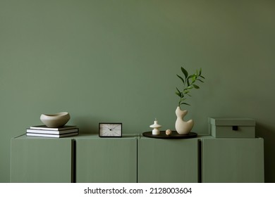 Modern living room interior composition with modern home decorations and personal accessories on the eucalyptus wooden commode. Sage green wall. Template. Copy space. - Shutterstock ID 2128003604
