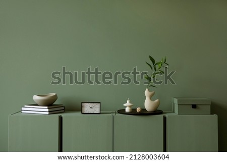 Modern living room interior composition with modern home decorations and personal accessories on the eucalyptus wooden commode. Sage green wall. Template. Copy space. Stock photo © 