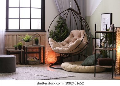 Modern living room interior with floor lamp and hanging armchair - Shutterstock ID 1082431652