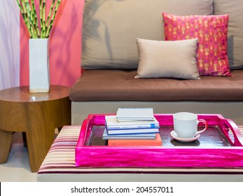 Modern living room with sofa and cup of coffee  in colorful tray