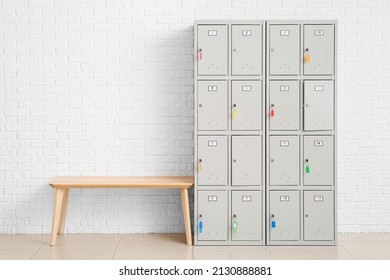 Modern locker and bench near white wall - Powered by Shutterstock