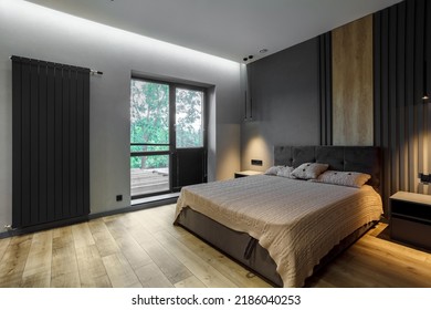 Modern and loft bedroom with dark and grey style. Dark headboard and wooden floor with glass window