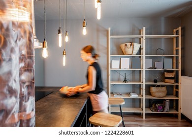 Modern Loft Dinning Room With Motion Blurred Woman Doing Housework