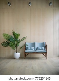 Modern Loft Living Room With Plywood Wall And Wooden Floor, Light Blue Retro Sofa With Pillows And Green Tropical Fern Plant. Lamps On The Wall Above. Mock Up Interior Photo Simple Urban Jungle Style