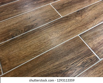 Modern Look Of The Porcelain Floor Tiles, Brown Color With White Grout Lines And Staggered Diagonal Pattern