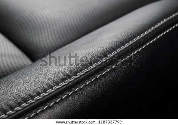 Modern\
luxury car black leather interior. Part of leather car seat\
details. Interior of prestige modern car. Comfortable leather\
seats. Black perforated leather. Car\
detailing