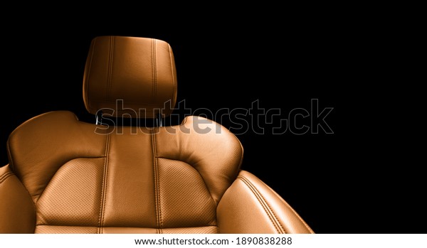 Modern luxury car brown leather interior. Part\
of orange perforated leather car seat details with white stitching.\
Interior of prestige car. Comfortable perforated leather seats.\
Perforated leather.