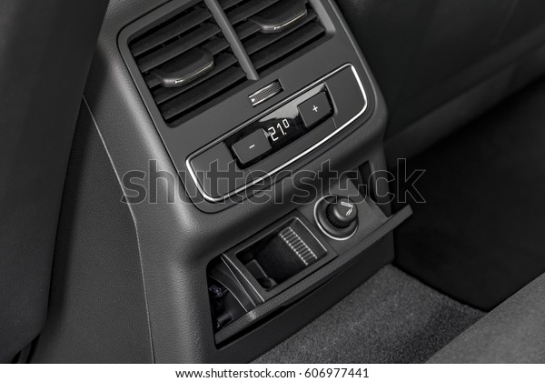 Modern luxury car central console with climate\
controls for rear\
passengers