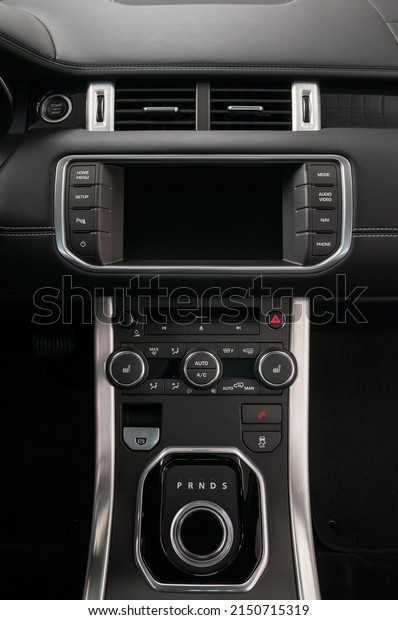 Modern luxury car control panel. Interior detail.\
Vertical photo.