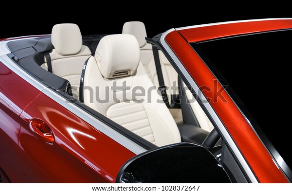 Modern Luxury car\
inside. Interior of prestige modern car. Comfortable leather seats.\
White perforated leather cockpit with isolated Black background.\
Modern car interior\
details
